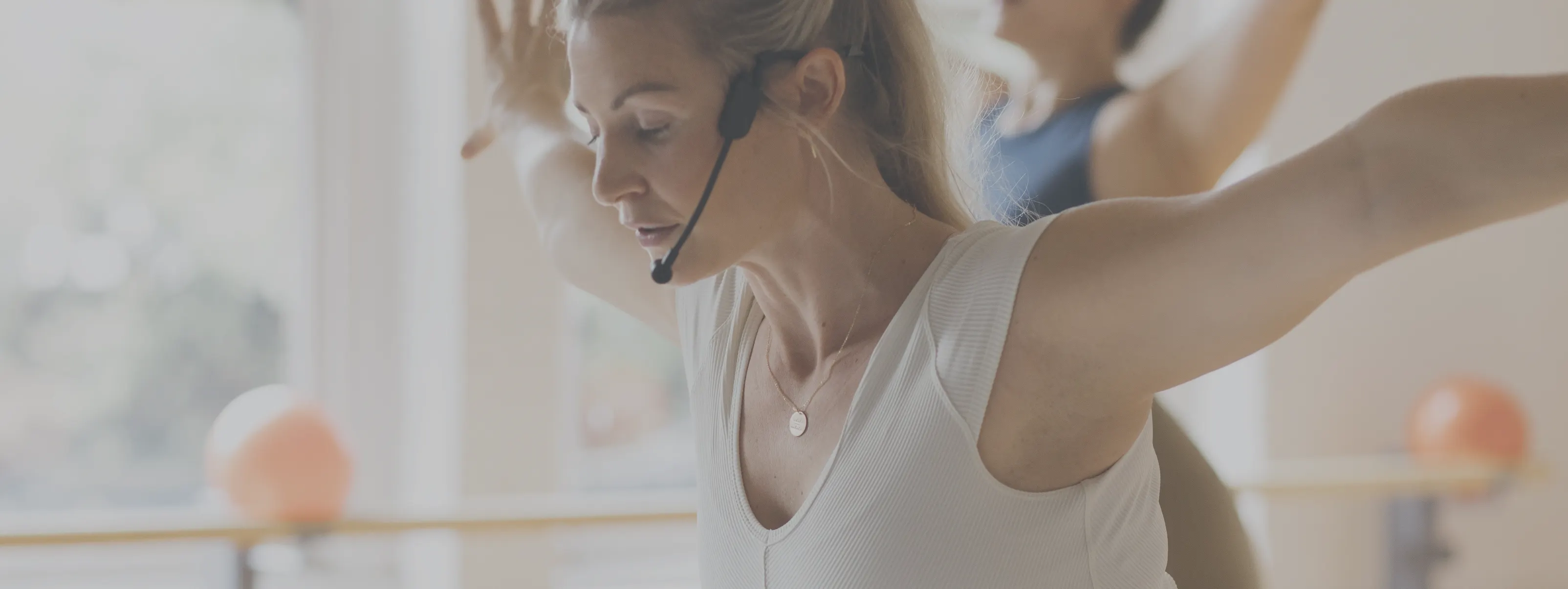 instructor on a microphone teaching a barre3 class