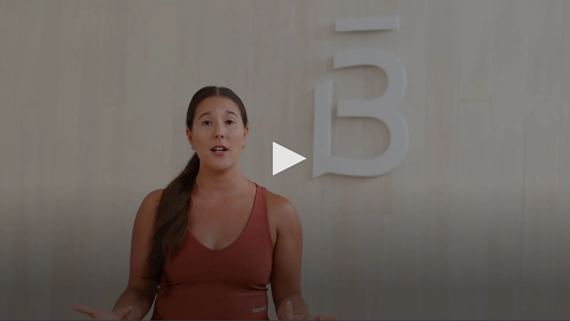 graphic over video, image of Kelly with play button over top. Press play to watch. 