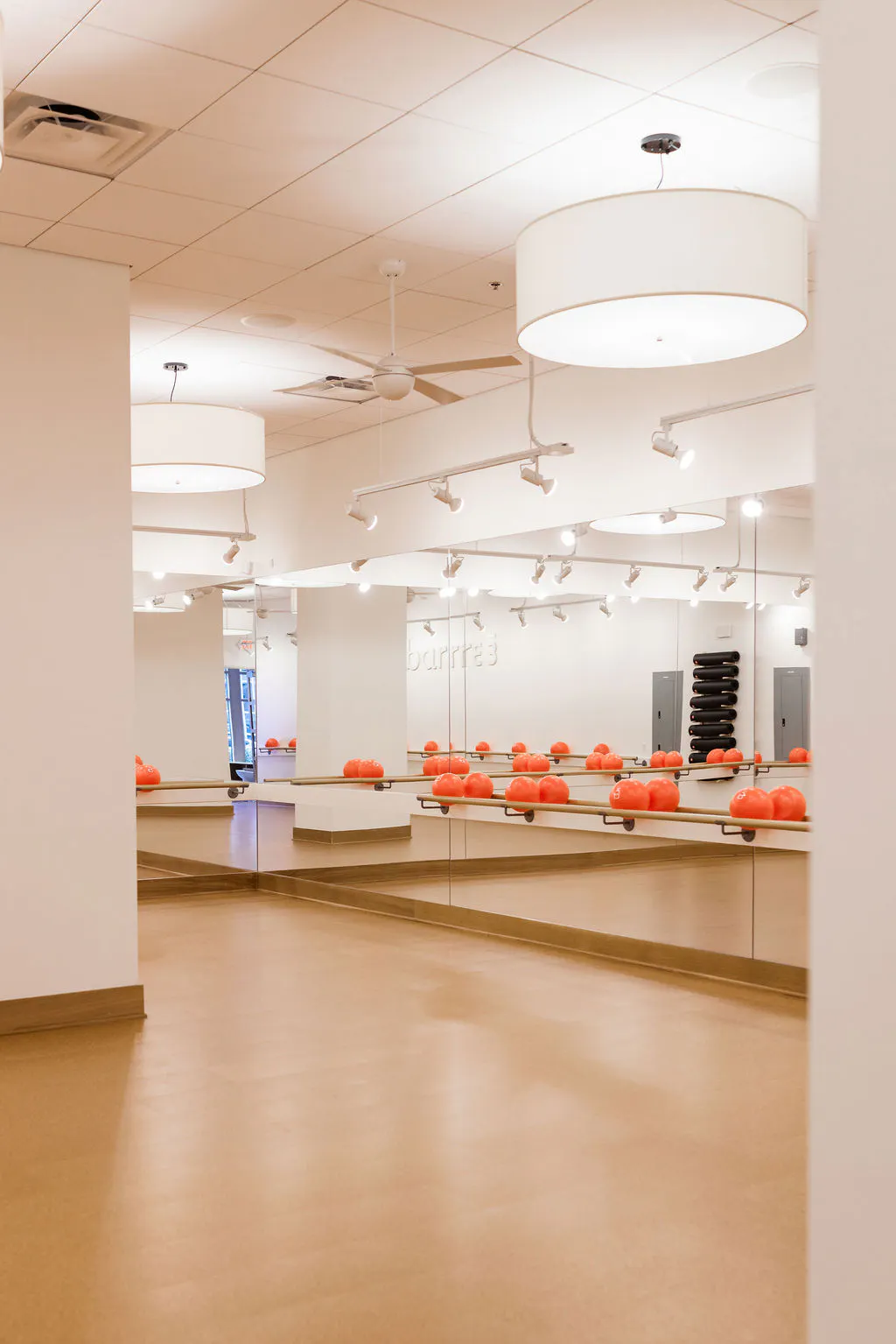inside the barre3 studio looking at mirrors and core balls on a barre rail