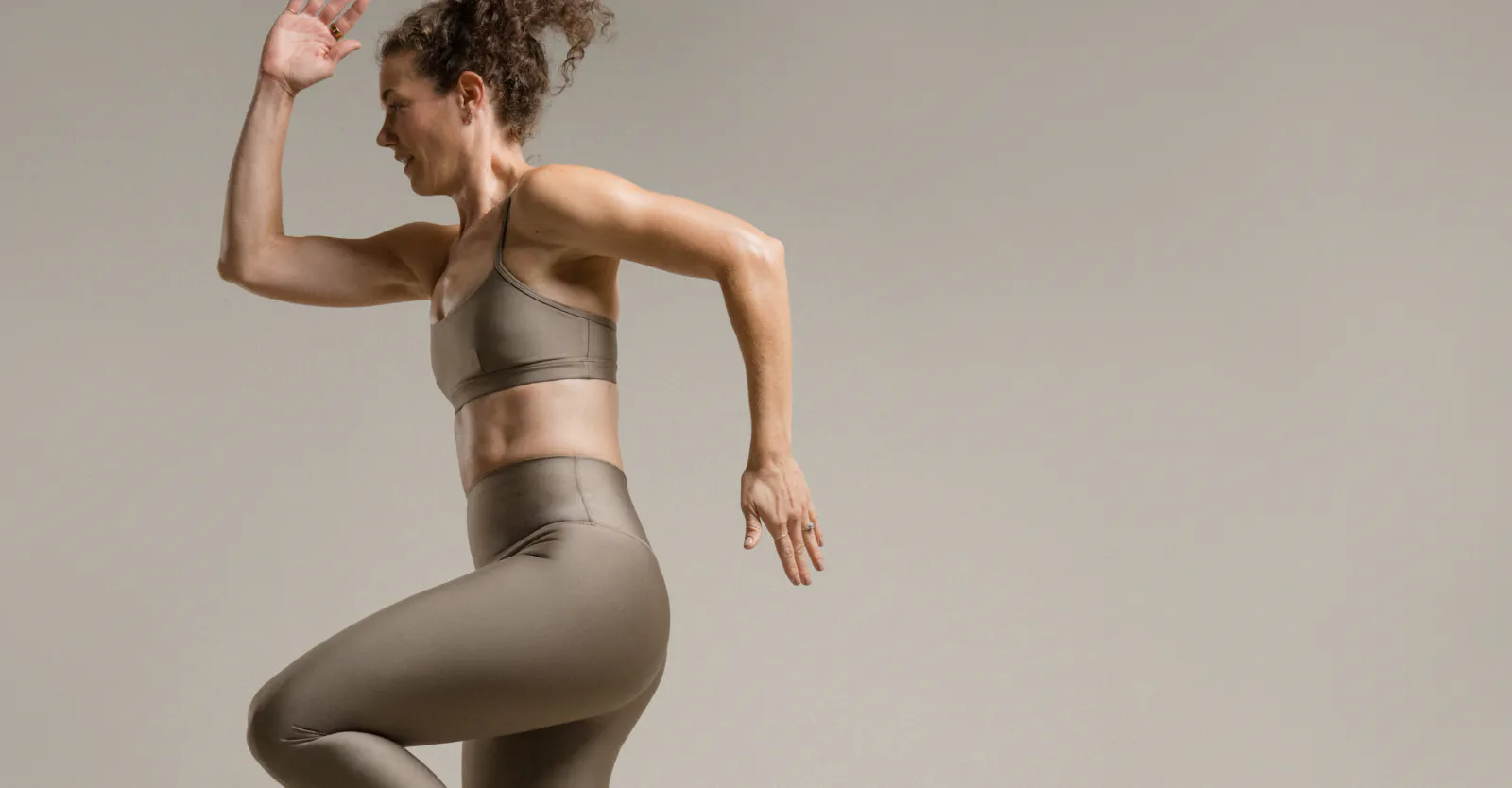 woman jumping with one knee up