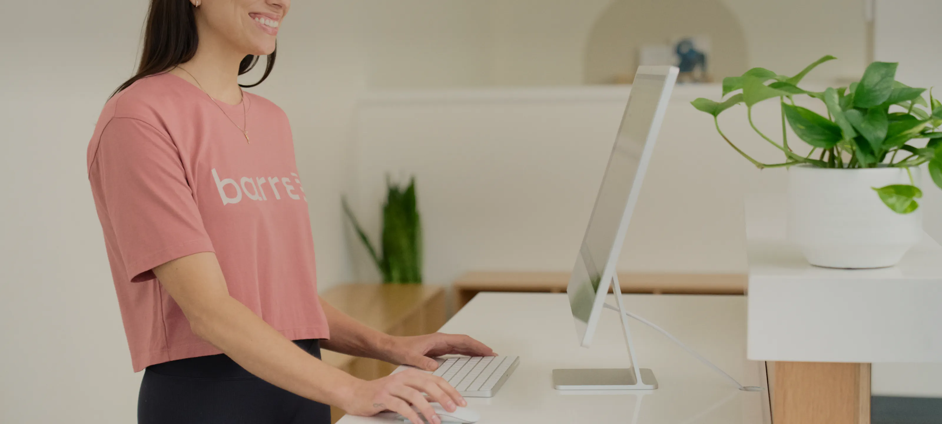 a woman at a front desk/reception area greeting clients