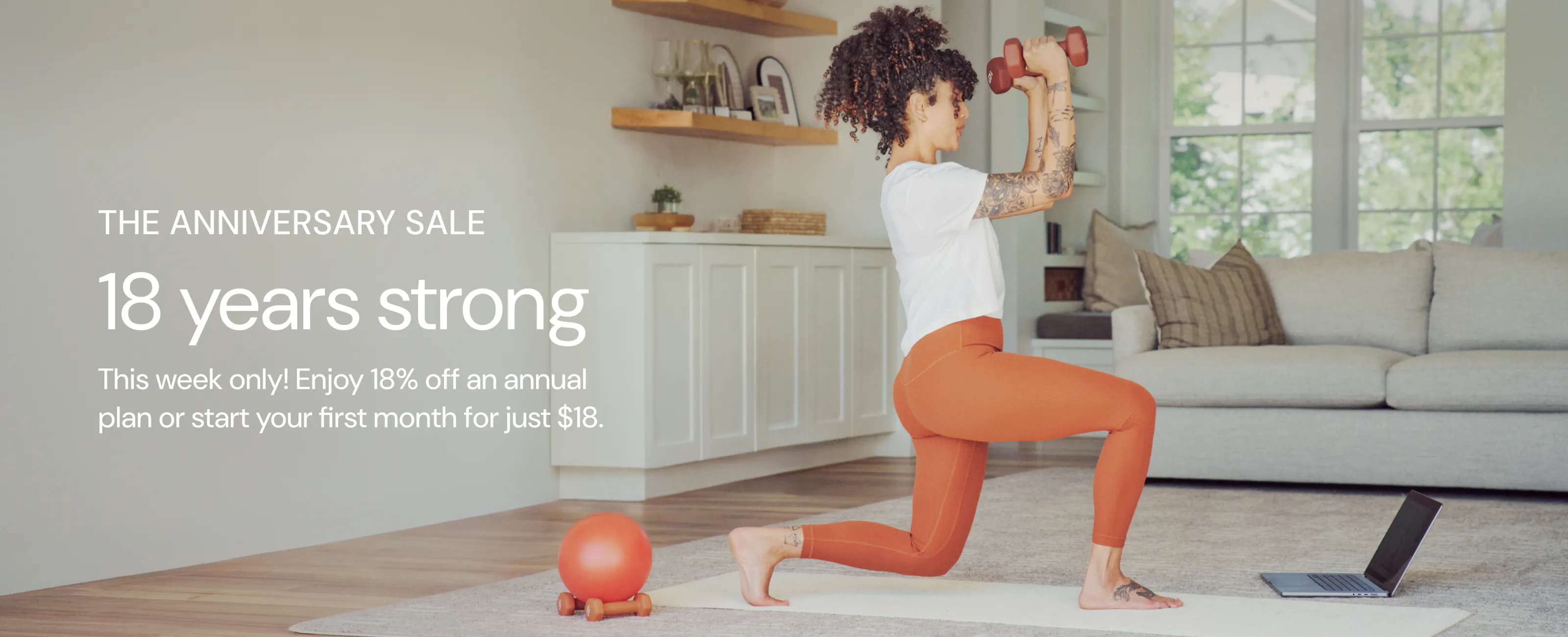 woman working out at home with weights in her hand with text saying: 18 years strong. the anniversary sale.